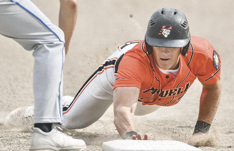 Trey Stenerson slides safely into first base during the Pioneers’ game against Evanston. Powell rolled over the first two games and dominated Evanston 13-3 and Rawlins 25-0.
