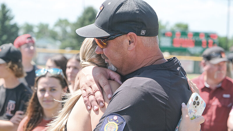 Jason Borders hugs his daughter, Maci, after the Pioneers won the state championship in Powell. Borders was inducted into the Wyoming Legion Baseball Hall of Fame during the opening ceremonies.