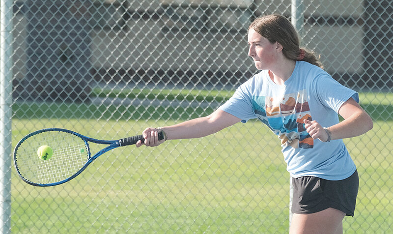 Sophomore Noelle Leighton reaches out to return a forehand during tennis practice on Tuesday morning. The Panther girls will look to replace four players who graduated from last years&rsquo; team.