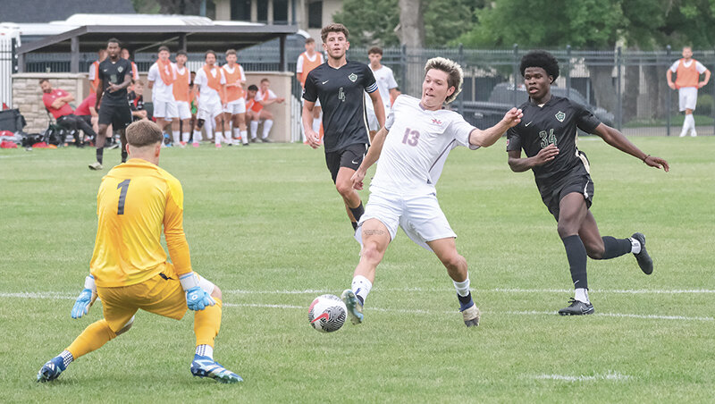 Tyler McCarthy stretches out to try and play a ball past the Rocky Mountain keeper in a preseason scrimmage. Northwest started the season with a win and a draw on the road last week.