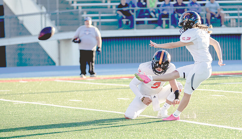 Ivy Agee kicks an extra point alongside holder Keona Wisniewski. Powell rolled past Douglas 34-14 on Friday night.