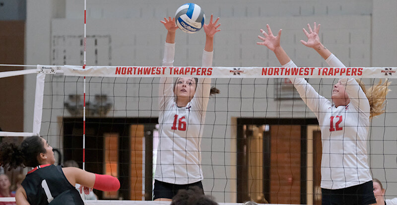 Taylee Carlson (left) and Tilli Danczyk get up to block a ball during the home match against Casper College on Sept. 28. Northwest returns home this Friday and Saturday before heading back on the road the following weekend.