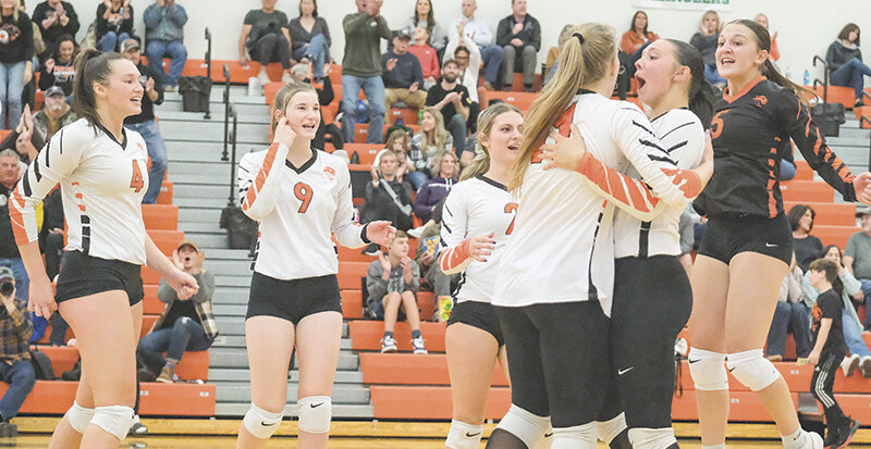Catelynn Floy hugs Addison Holcomb as the Panthers celebrate after a Holcomb kill in the fourth set Tuesday against Cody. From left: Saige Kidd, Leah Graham, Peyton Borcher (behind), Holcomb, Floy and Alexa Richardson.