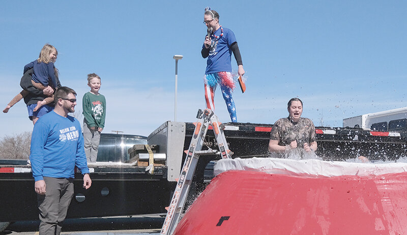 Hartly Washington, a Powell Middle School special education teacher, takes the plunge during this year’s Jackalope Jump in late March. From left, Maggie Purdum and Bennett Purdum, Rick Mertz of Big Horn Enterpises, and Washington. In front is Powell Police Officer Matt Koritnik.