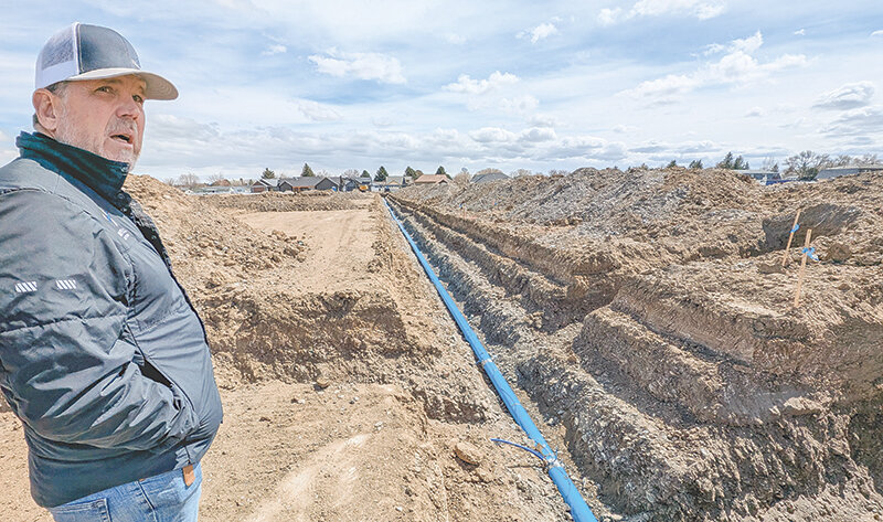 Chad Harvell of Harvell Construction talks about the second phase of his Cottonwood Village subdivision on April 18. Workers are currently installing the infrastructure for the 30 new lots, including water and sewer lines.