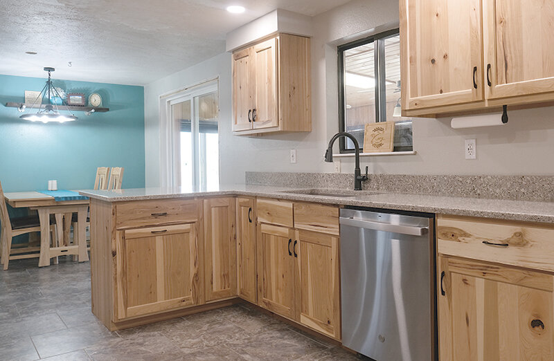 Cabinetry from Mountain View Mouldings showcases the unique character of the wood and works well with the colors in the Kary&rsquo;s home.