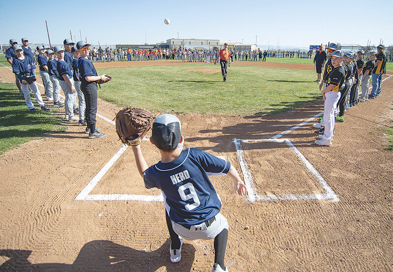 Yankees catcher Paxton Herd catches the first pitch from Powell sports celebrity Dave Fink to kick off the 2025 Powell Little League season. The season runs through June for most of the players in the league with Majors All-Stars playing into July.