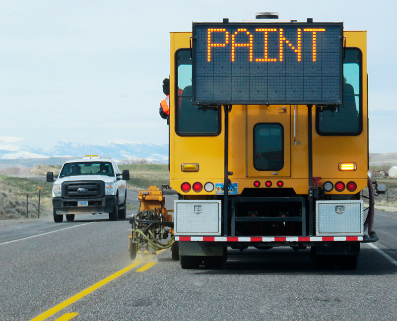 WYDOT workers perform highway centerline striping.
