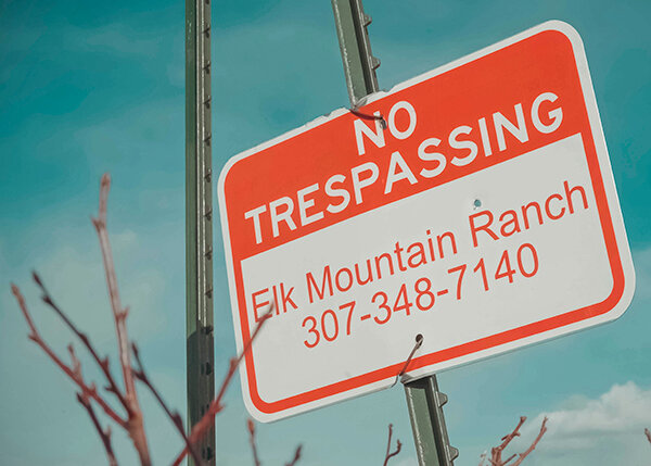 Sign at the common corner of public and private checkerboard-pattern property at Elk Mountain Ranch.
