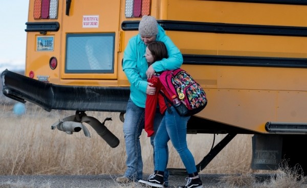 A mother comforts her child on Monday afternoon after a Powell school bus was hit by a pickup at the intersection of Lane 5 and Road 8. The bus was involved in another crash earlier in the day.