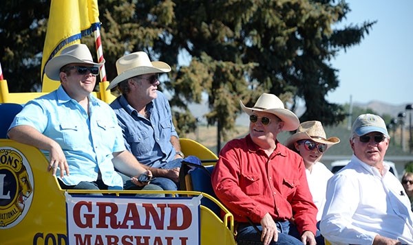 Craig Johnson (second from right), author of the Longmire series of books, rides in the grand marshal truck along with TV series stars Adam Bartlett (left) and Robert Taylor (second from left), during the Cody Stampede Fourth of July Parade last month. The 13th novel in the Longmire series, “The Western Star,” hits shelves in September.