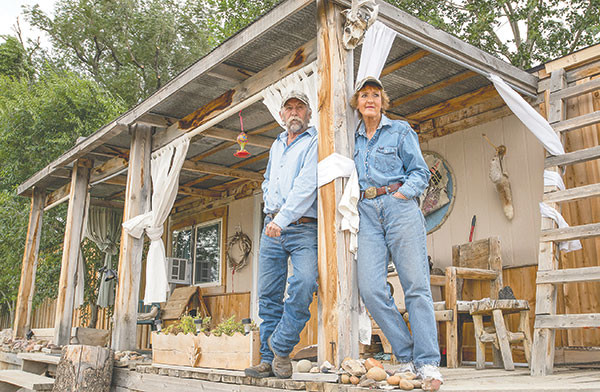 Doug and ’Genie McMullan on their front porch at their ranch near Deaver Reservoir. They are in a constant struggle to keep their property safe from rattlesnakes, including near their home, and have had several pets and a goat bitten by the venomous snakes.