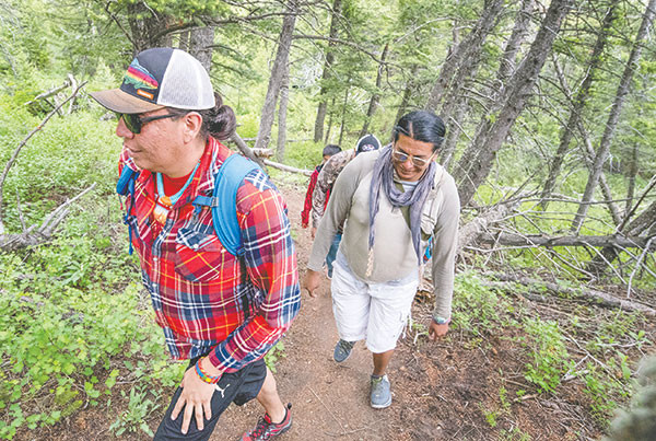 Noel Two Leggins (left) leads a group of Crow youth on a hike to the summit of Heart Mountain, or as they know it, Foretop’s Father. Two Leggins has been instrumental in bringing young tribal members to the mountain to learn about their heritage.