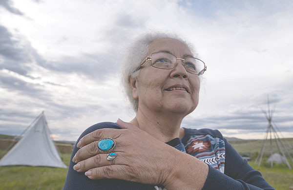 Rhoda Anderson, an Arapahoe resident of Wind River Reservation, heads to breakfast at The Big Quiet campground before climbing Heart Mountain to witness a ceremonial pipe lighting by Crow elder Grant Bulltail.