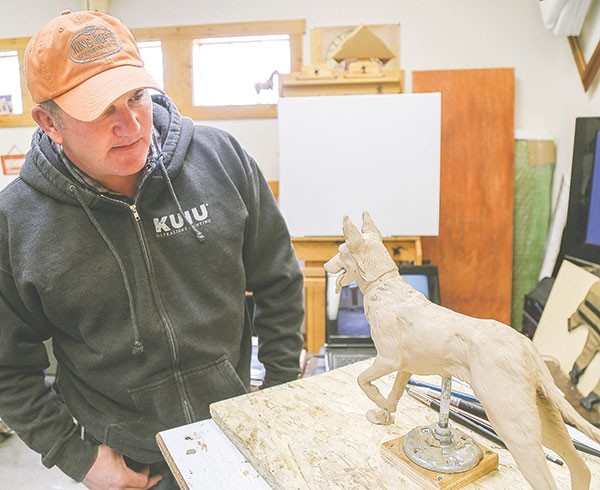 Veteran Matthew Bessler of Powell is pictured with a miniature model of a dog statue. A memorial at the Wyoming Veterans Memorial Park in Cody will feature a dog and handler, modeled off of Sgt. 1st Class Bessler and his military combat/service dog Michael.