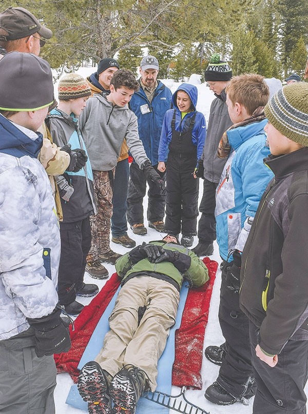 Boy Scouts from Lovell, Cody and Powell underwent winter survival and first aid training at Camp Buffalo Bill Saturday. A stretcher for the ‘victim’ must be fashioned PDQ from whatever material can be found, including blankets, a sleeping bag or, if handy, a rake.
