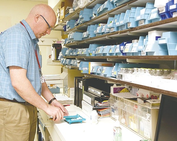 Pharmacist Gareth Robertson of Powell Valley Hospital works at the pharmacy at North Big Horn Hospital in Lovell on March 25. Powell Valley Healthcare sends a pharmacist to Lovell three times per week.