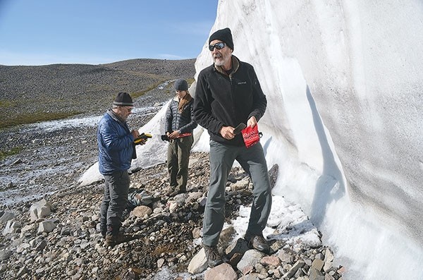 University of Wyoming professor Robert Kelly (foreground), Colorado State University professor emeritus Larry Todd (at left) and Cambridge University student Rachel Reckin (center) document materials at a melting ice patch high in the Shoshone National Forest in this summer 2015 photograph. Todd and other researchers plan to return to the area next summer.