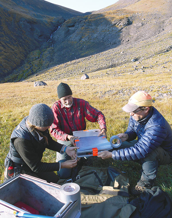 From left, Cambridge University student Rachel Reckin, University of Wyoming professor Robert Kelly and archeologist John Laughlin with the Wyoming State Historic Preservation Office package up a roughly 625-year-old fragment of a wooden bow found in the wilds of the Shoshone National Forest last summer. Photo courtesy Larry Todd