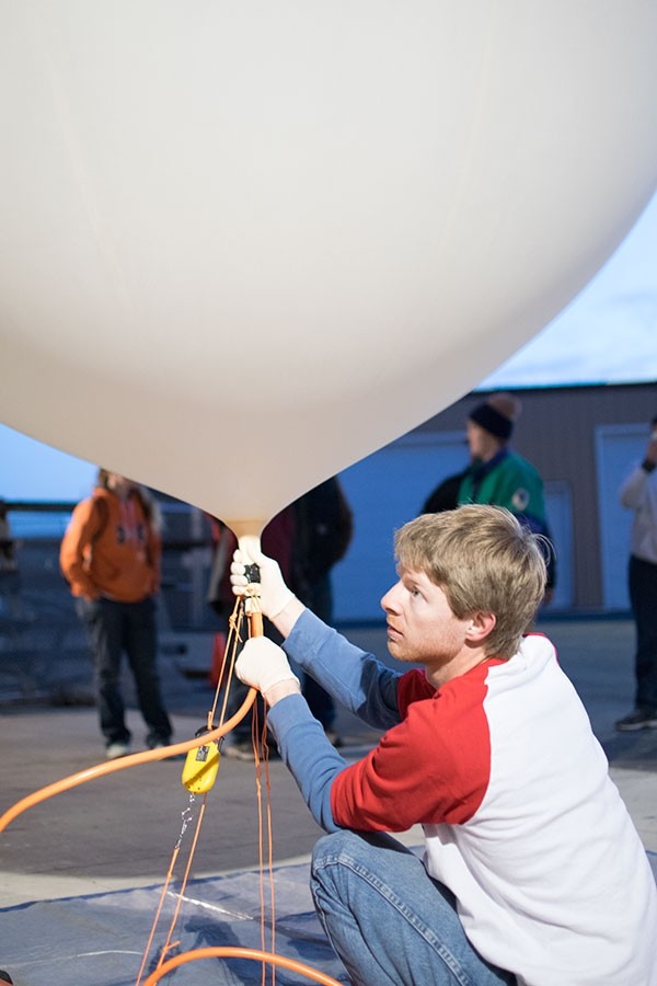Phil Bergmaier fills a weather balloon with helium on the morning of April 10 at Powell High School. Bergmaier, a graduate fellow in atmospheric science with the University of Wyoming Science Posse, led the weather balloon project for Powell students.