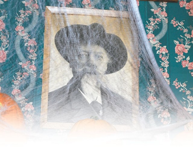 A portrait of Buffalo Bill Cody peers out from behind a cobweb decoration added to the hotel during the Halloween season. Cody, who built the hotel in 1902, died in 1917, but some say his spirit still lingers in his hotel.