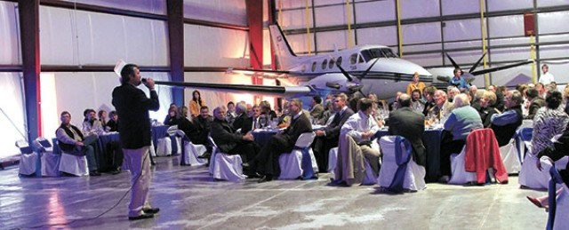 An airline hangar made an unusual venue for the annual Northwest College Foundation banquet in Cody on Friday. The Choice Aviation hangar and accompanying airplane props served as reminders of the banquet’s purpose: to raise money for scholarships to help students entering the college’s new aeronautics degree program next year. Here, auctioneer Mark Musser takes bids on one of three flight-related auction items. The banquet raised about $10,000 for an aeronautics scholarship program.