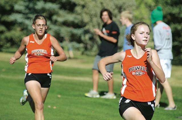 Powell’s Tally Wells (left) runs a couple steps behind teammate Sierra Morrow as the pair push through the final 100 yards of the 3A West championship course. Both girls earned all-conference honors, but a talent-laden field kept the Panthers fourth in the final team standings.  Tribune photo by Randal Horobik