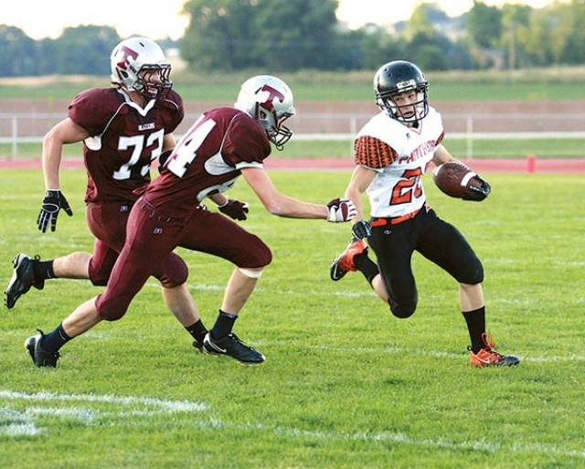 Sophomore Cory Heny sweeps around the left side of the line during a rushing attempt on Friday night in Torrington. After a 49-0 victory, the Panther gridders are poised to move into the No. 1 spot in Class 3A.