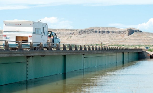 The waters of Big Horn Lake lap at the bottom of the bridge beams at the US. 14A causeway across the lake. The lake is nearing record levels as heavy runoff from last winter’s heavy mountain snowpack continues. The Bureau of Reclamation has forecast that the lake will likely rise another foot before the runoff eases.