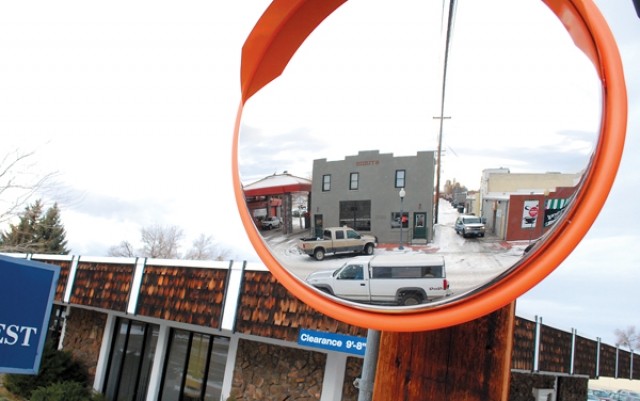 A mirror positioned on a pole near Bank of the West reflects traffic and pedastrians to help drivers coming out of the alley onto Second Street.