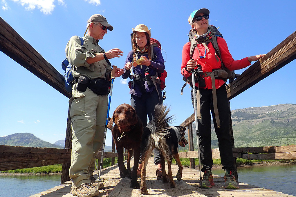 Scott Wolff of Duluth, Minnesota, visits with Virginia Schmidt (center) and Jessica Williams (right) after a chance encounter at a pack bridge at Hawk’s Rest, along the Yellowstone River in the Thorofare.