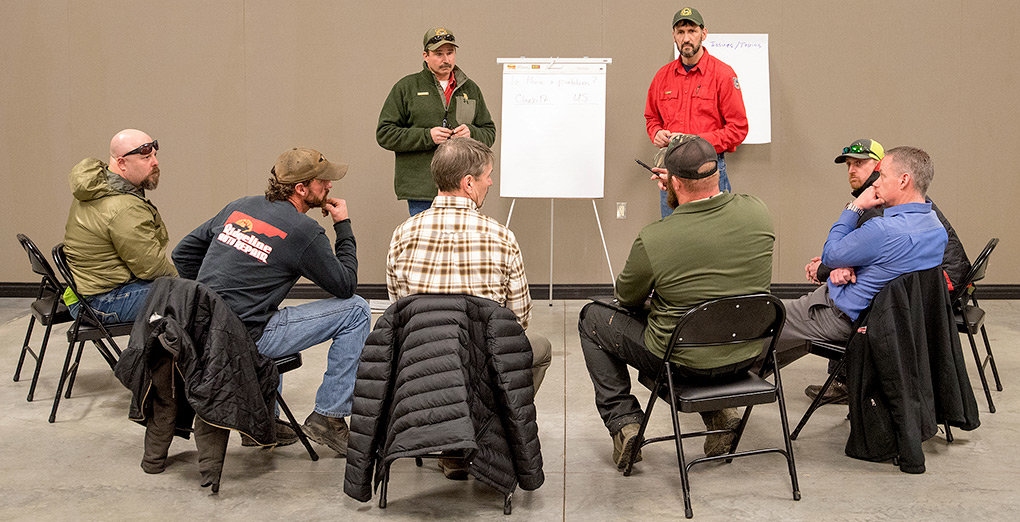Powell Game Warden Chris Queen (left) and Wyoming Game and Fish Terrestrial Habitat Biologist Jerry Altermatt lead a discussion about local mule deer herd numbers at the Park County Fairgrounds on Feb. 19. The meeting was an effort to gauge support for possible regulations to help boost mule deer herd numbers.