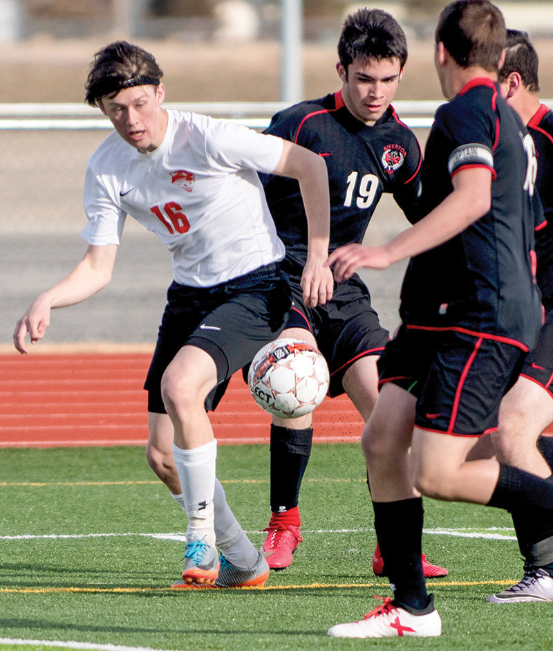 Panther soccer player Sam Bauer works the ball away from a trio of Riverton defenders during a game last season. Bauer and his teammates will open the 2019 season on Saturday in Buffalo, if the weather cooperates.