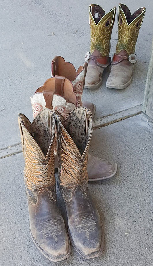 Cowboy boots sit on a porch at Ron and Janis Adams’ Crazy Cayuse Ranch during a five-day horse camp.