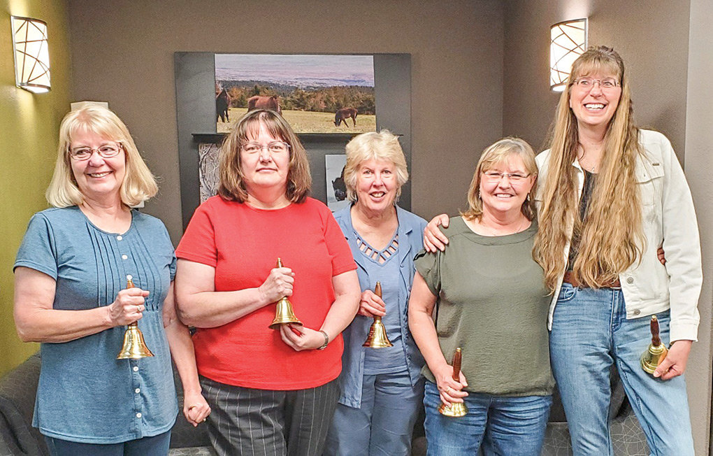 From left, retiring Powell school employees Jocelyn Frame, Gloria Randall, Laurie Smith, Deb Eckhardt and Laurie Zwemer pose for a photograph at a school board meeting last month. The board and school administrators presented the retirees with bells and thanked them for their many years of service.