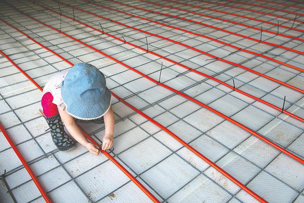 Scarlett Wood, daughter of Pat and Sara Wood, attempts to help her parents with the construction on a special heated floor in their facility. It’s being prepared for traditional floor malting.
