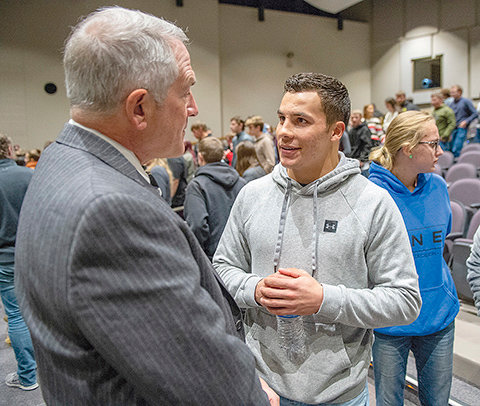 Powell High School senior Brody Karhu visits with University of Wyoming Acting President Neil Theobald during the president’s Thursday visit to Powell and Park County. Theobald said he visited with students about the many opportunities offered by a college education — not just at UW but also at Northwest College and other institutions.