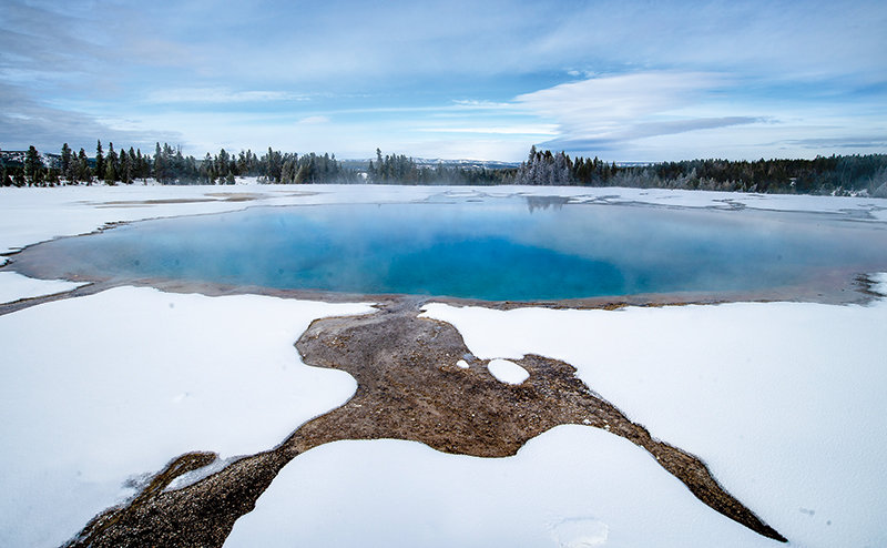 The colors of Turquiose Pool, in the Midway Geyser Basin at Yellowstone National Park, contrast with a layer of fluffy snow Saturday. The Hayden Expedition of 1878 named the pool for its ‘milky, white bottom and gem-like, blue-colored water,’ according to the park website.
