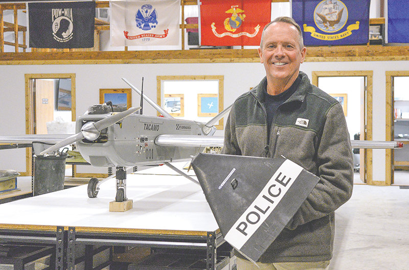 Thomas Rullman, president and CEO of GT Aeronautics, holds a bandito drone inside the company’s hangar at the Powell Municipal Airport. In military operations, the banditos can be used against ground or air targets. On the table is Tacamo, which can hold two of the banditos.