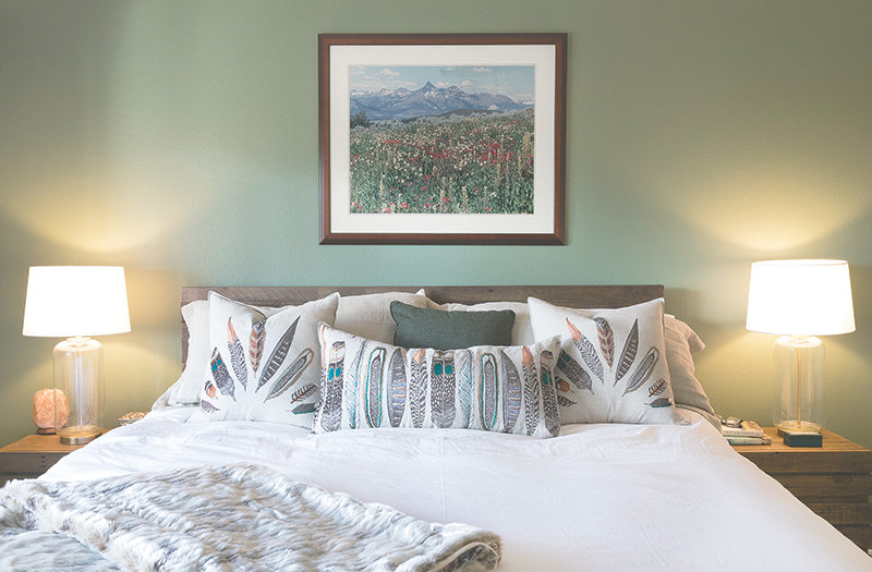 The new master bedroom features a soothing cedar green (Benjamin Moore Cedar Path 454) on the walls, with faux fur accents and pillows by Coral & Tusk.