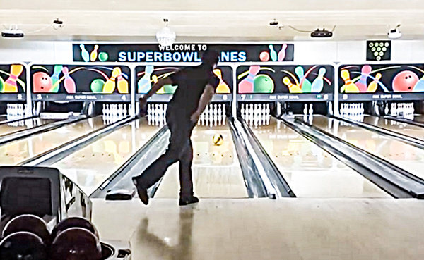 Powell bowler Ty Whiteman watches his ball head down the lane and toward his 12th and final strike to complete his perfect 300 game on Jan. 24 in Cody.