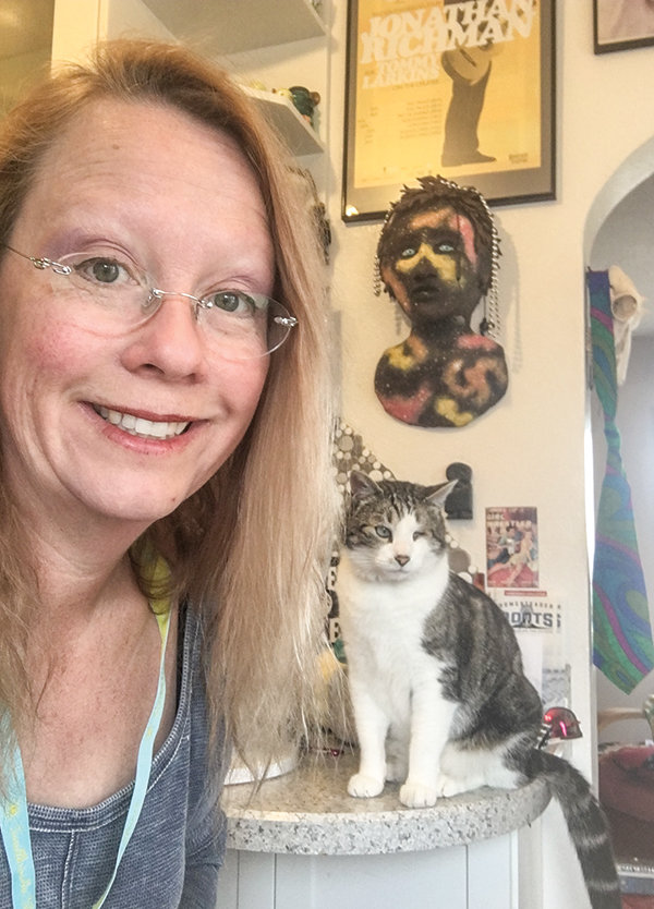 Justine Larsen’s pets — including Wink, pictured with Larsen above — have helped keep her young students engaged in their online lessons.