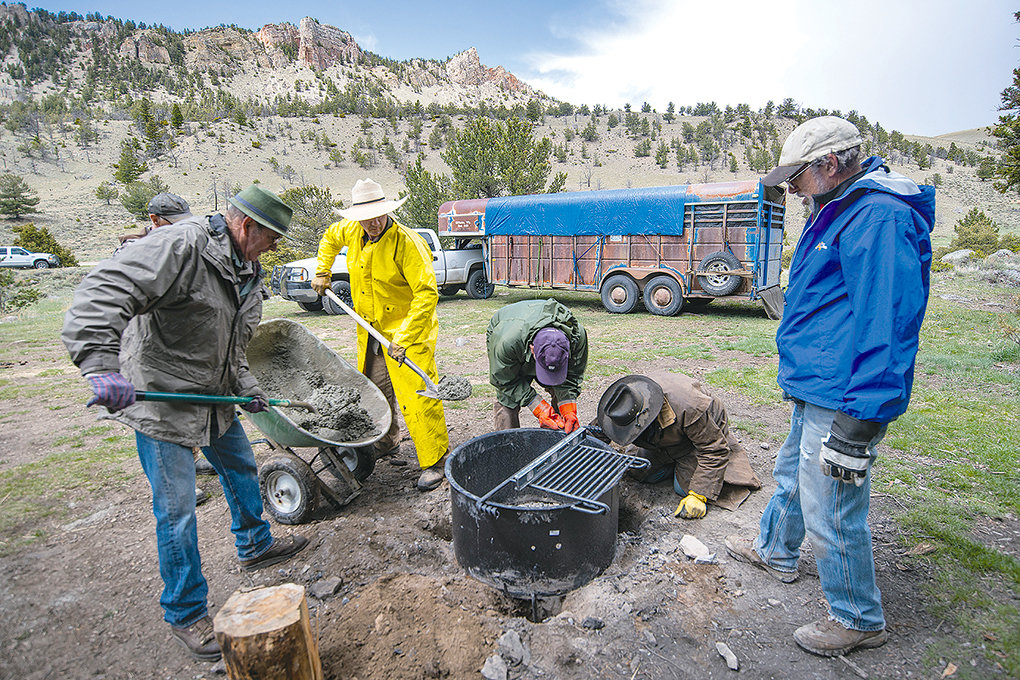 Shoshone Back Country Horsemen members Jim Hanchett, Frank Fagan, Walter Haslett, Dale Olson and Bud Melcher work to install a fire ring at Dead Indian Campground in the Shoshone National Forest earlier this month.