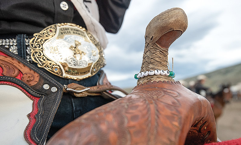 Rylee Ramsey places a small handmade bracelet, with beads spelling ‘FIGHTER,’ on her saddlehorn every time she rides. The bracelet was made in memory of her grandfather.
