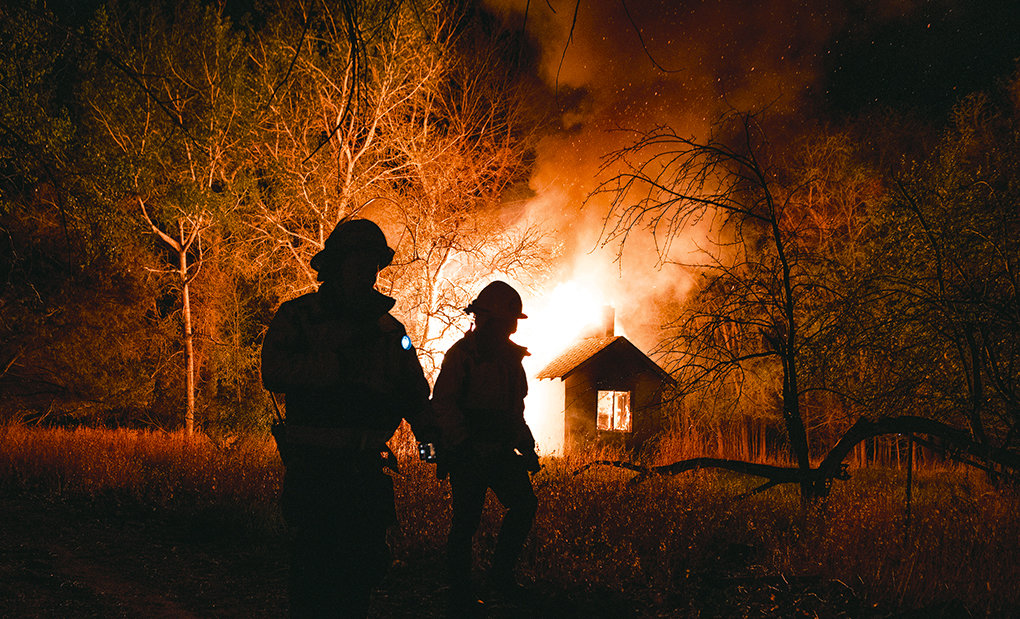 Members of the Powell Volunteer Fire Department work to extinguish a blaze at an abandoned home south of town on May 17, 2019. Last month, the Park County Attorney’s Office charged a 19-year-old man with arson in connection with the fire and a prosecutor said two teens will face charges in juvenile court.