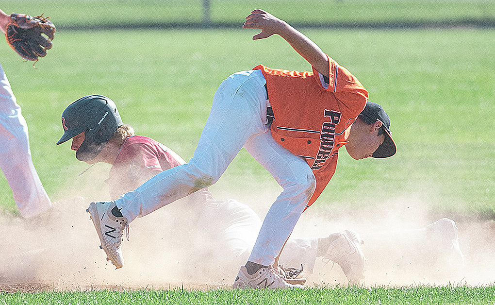 Ethan Welch attempts to tag out a runner stealing from second during a Tuesday home game against Riverton. The Pioneers split the doubleheader.