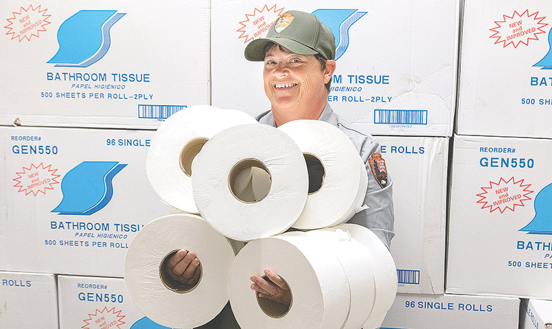 A Yellowstone National Park facility management employee shows off an abundance of toilet paper in the park this summer. But with camping and other overnight facilities closed due to the pandemic, visitors are camping outside the park and finding bathroom and shower facilities scarce. The result is human waste littering the area.