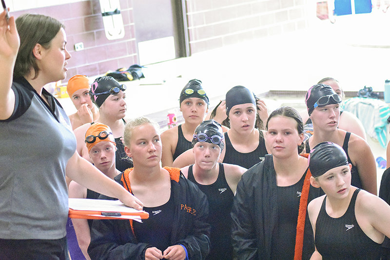 PHS assistant swim coach Bailey Jackson speaks with her athletes at the Riverton Pentathlon. In total, the team achieved 24 state cuts. From left, Dakota Hansen (in back), Emma Brence, Emma Bucher, Lucia Harder, Kylie Kahl, Kathryn Brence, Addison Moretti, Gabby Patterson, Sarah Miller and Paige Thomas.