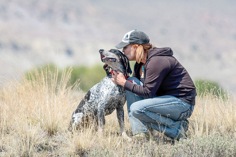 Tessa Fowler pauses for a moment with Warden, one of her three bluetick coo...
