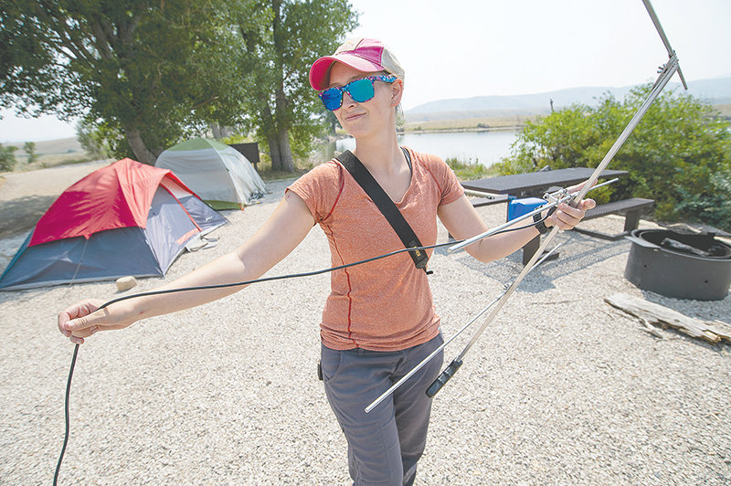Kayla Ruth, a biologist working on a sage grouse study in the Big Horn Basin, assembles her antenna at camp. The team was forced to camp at Hogan Reservoir during the hottest three weeks of the year due to COVID-19 rules from Oregon State University.